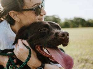 A woman giving her lab a hug